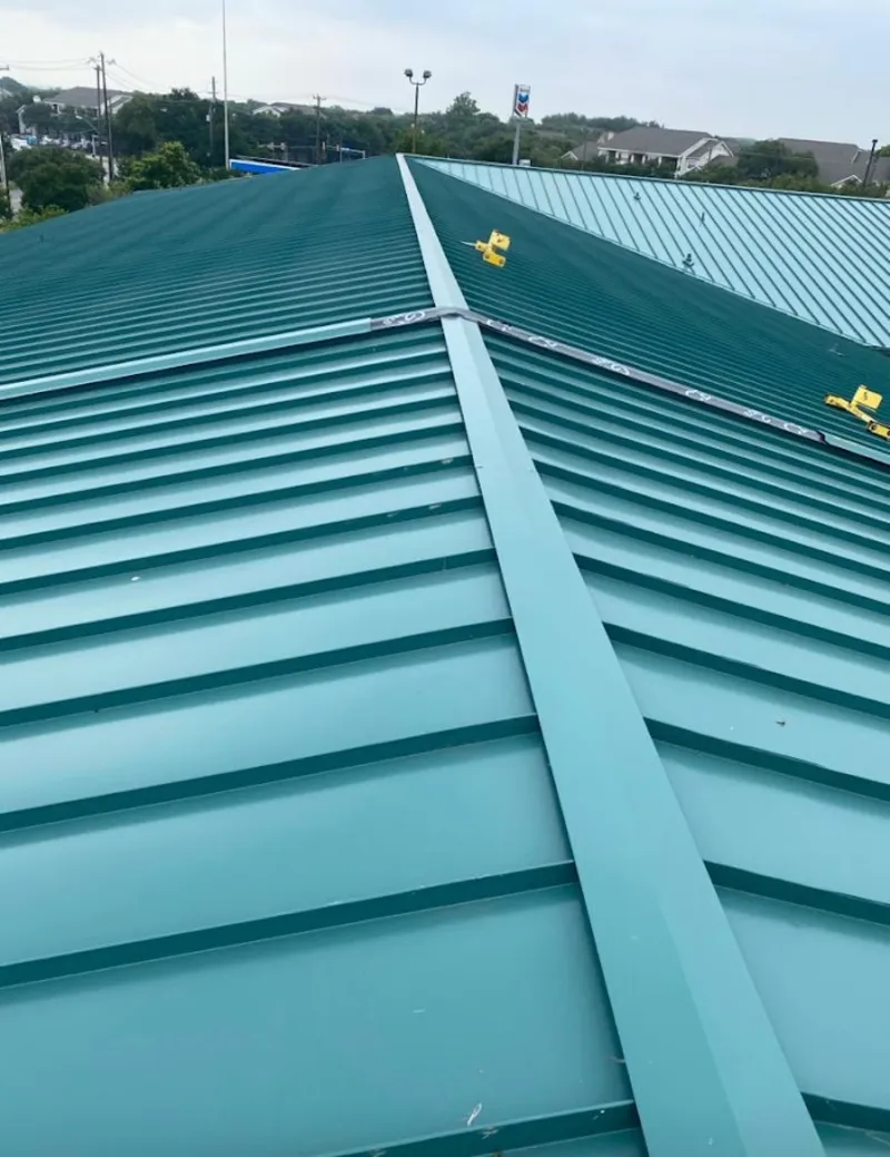 Green commercial metal roof ridge and valley for Metal Roof Repair in St. Andrews